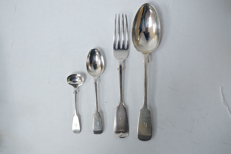 A part canteen of Victorian provincial silver fiddle pattern flatware by Josiah Williams & Co, Exeter, 1881, comprising six table forks, six tablespoons and eleven teaspoons, all with engraved initial, together with four